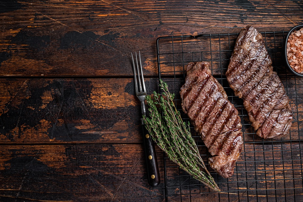 grilled-denver-beef-meat-steak-wooden-background-A6VNC7Q.jpg